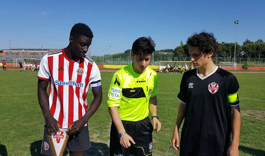 Soccer players and referee at coin toss before Riviera Summer Cup game