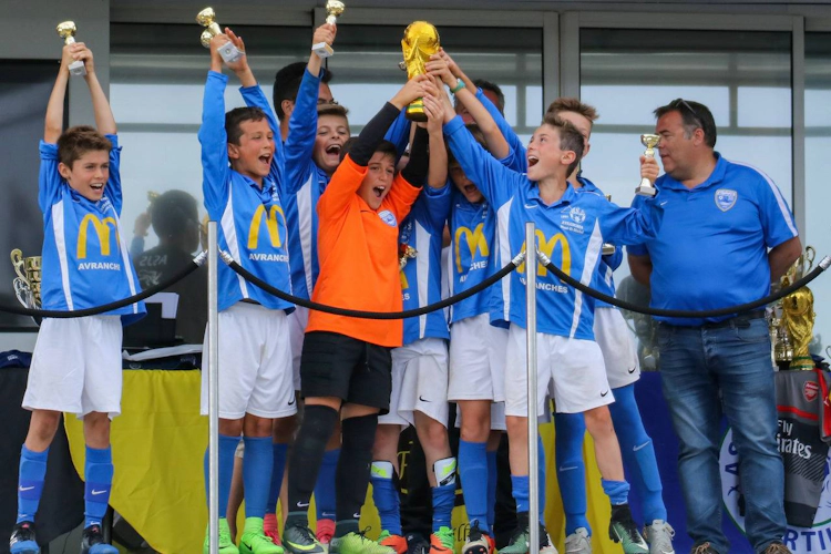 Young footballers with trophy at Tournoi International Sartilly