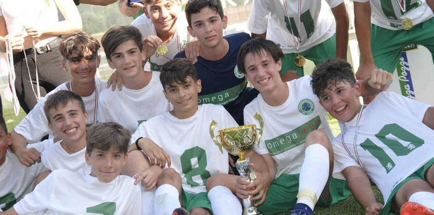 Young footballers with a trophy at the Versilia Cup.