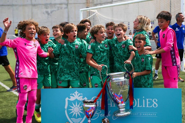 Young footballers celebrate winning at the Villa de Peguera Tournament