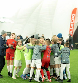 Youth football team celebrating a victory at the iSport January Cup tournament