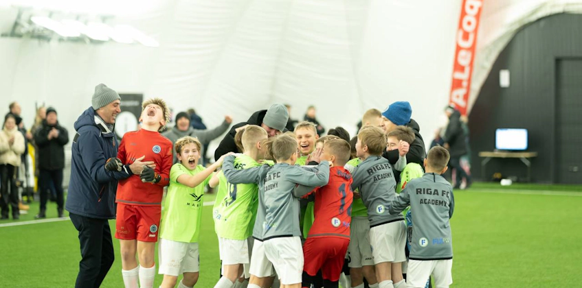 Youth soccer team celebrating a victory at the iSport January Cup tournament