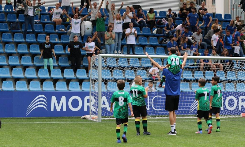 Youth soccer team celebrating a goal at the Copa Andorra tournament