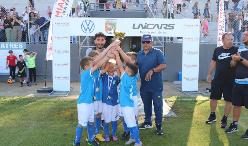Young soccer players with a trophy at the Platres Football Festival June tournament