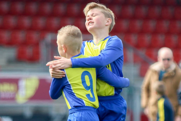 Young soccer players embracing at the Walibi Cup June soccer tournament