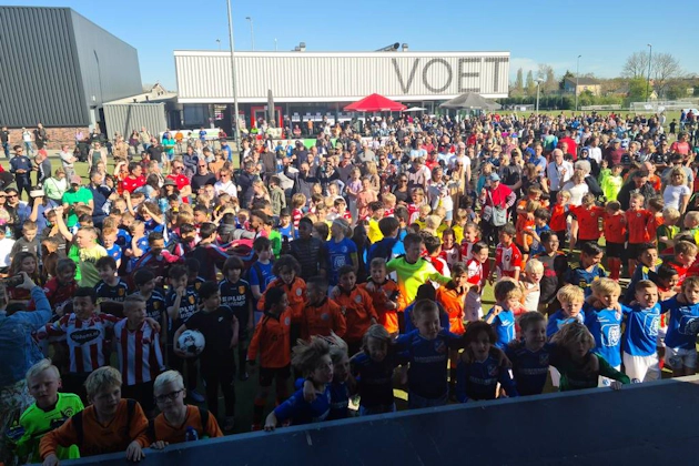 Large gathering of children in soccer uniforms at Limburgse Peel Cup tournament