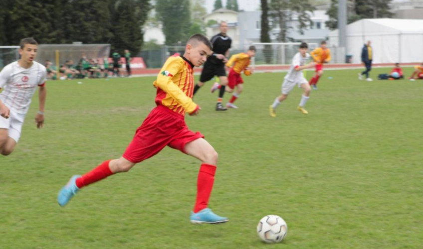 Player in red strikes the ball at Trofeo Città di Jesolo football tournament