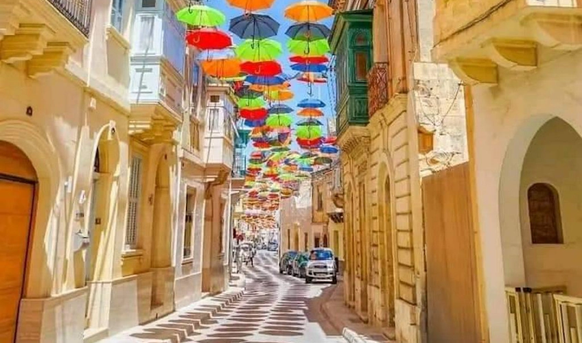 Színes ernyőkkel díszített utca egy történelmi városban