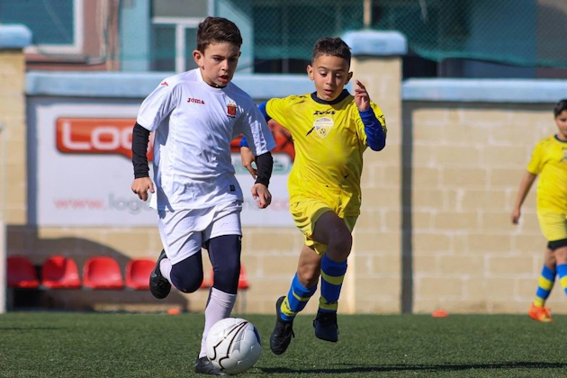 Young players competing in a soccer match at the U9 KHS Cup