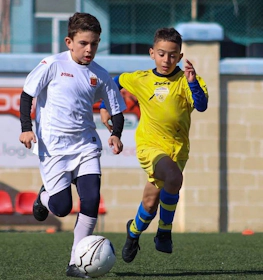 Young players competing in a soccer match at the U9 KHS Cup