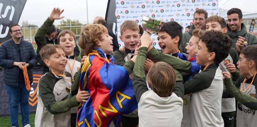 युवा फुटबॉल खिलाड़ी Esei Madrid Spring Elite Cup टूर्नामेंट में जीत का जश्न मनाते हैं