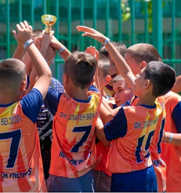 Youth football team celebrating with trophy at Olympia Easter Cup 2024