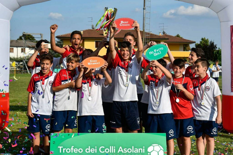 Youth soccer team celebrating with trophy at Trofeo dei Colli Asolani