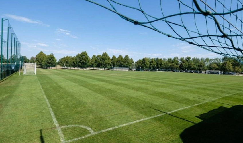 Čatež football field with green grass and goals under a clear sky