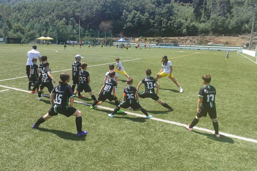 Youth soccer team doing pre-game warm-ups at the Alijó Cup tournament