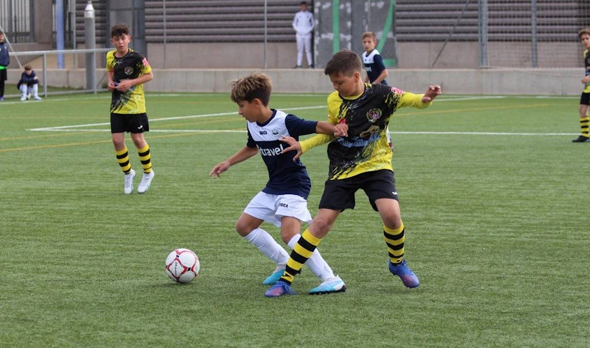 Young football players competing in Madrid Youth Cup summer tournament